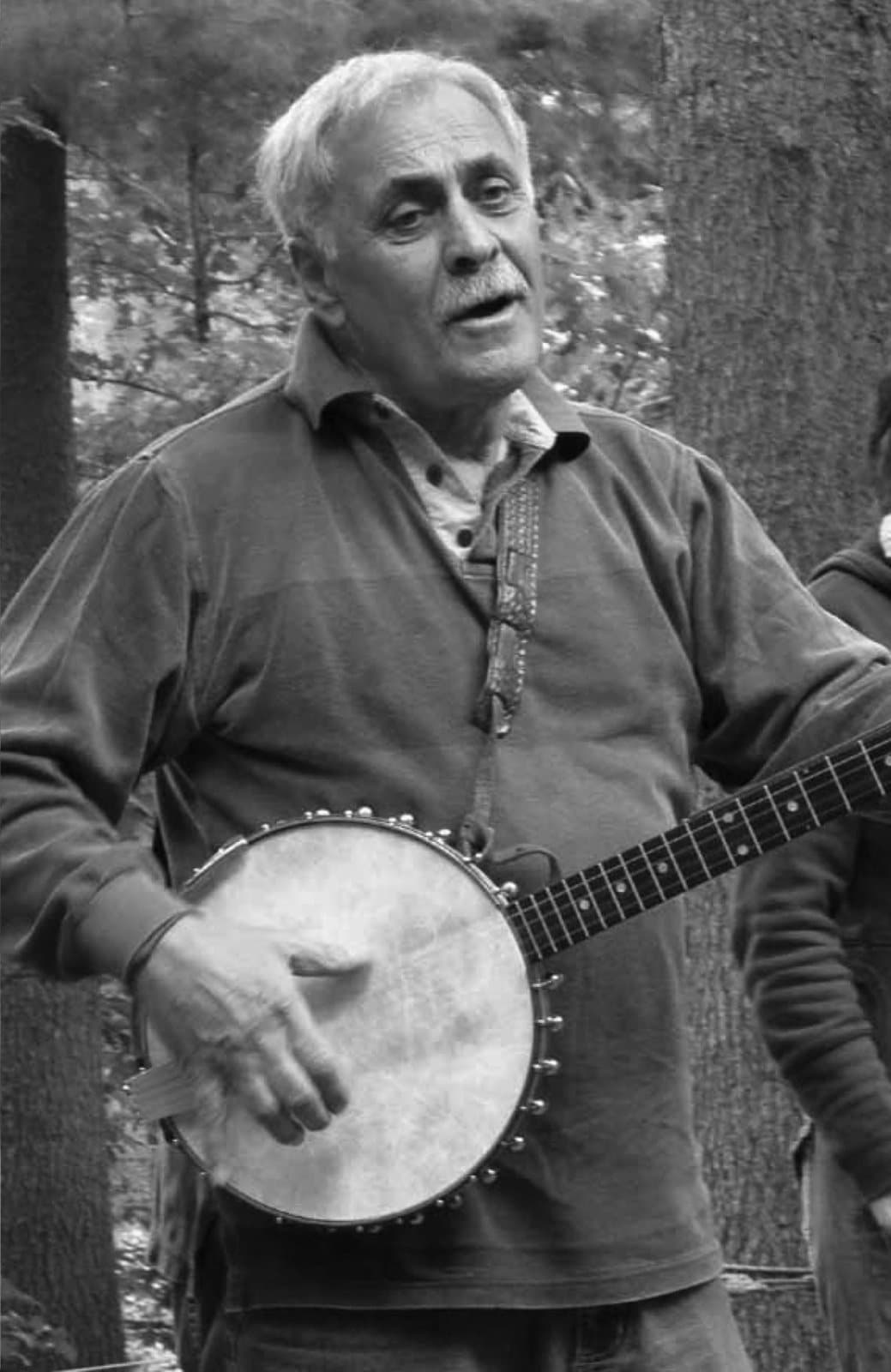 Richard Herman in later years, playing the same banjo among the pines.